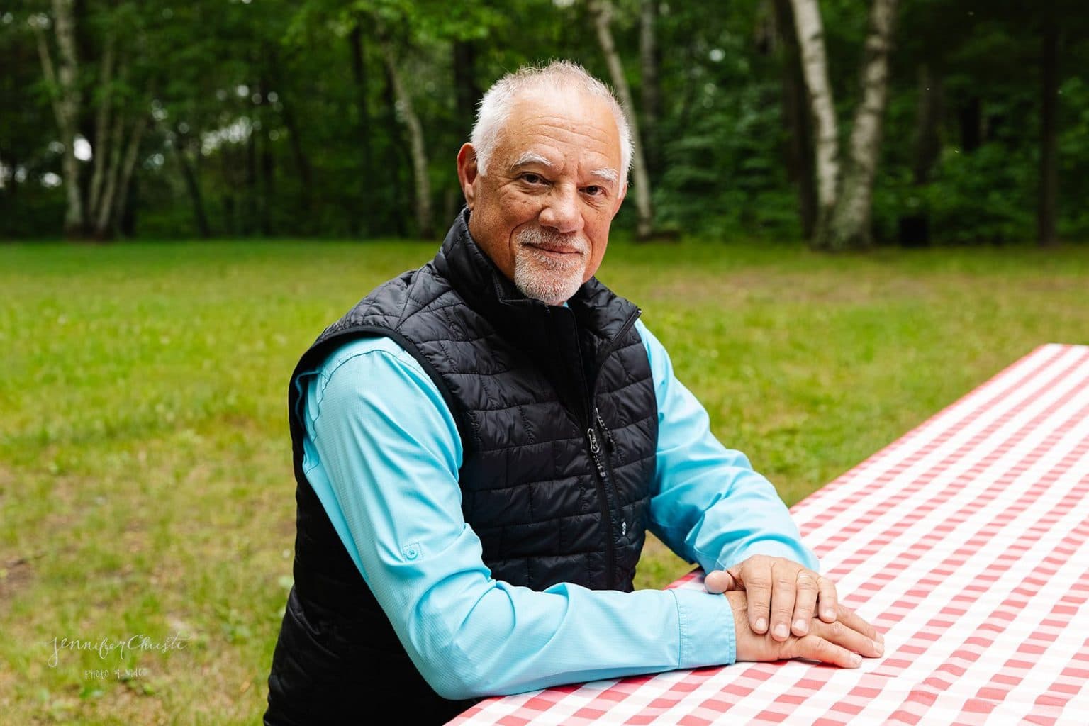 Curt Soehl seated at a picnic table outdoors on a summer afternoon